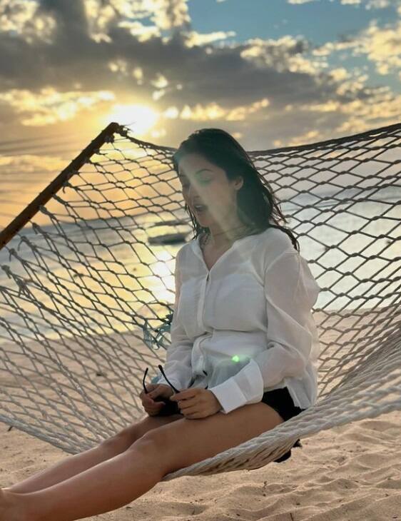 વ્હાઇટ ટૉપ-ડેનિમ શૉર્ટ્સ સાથે બીચ પર શહેનાઝની હૉટ અદાઓ