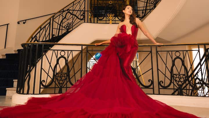 Fashion and beauty influencer Niki Mehra made her Cannes debut this year. For one of her red carpet looks, she turned heads in a bright red gown.