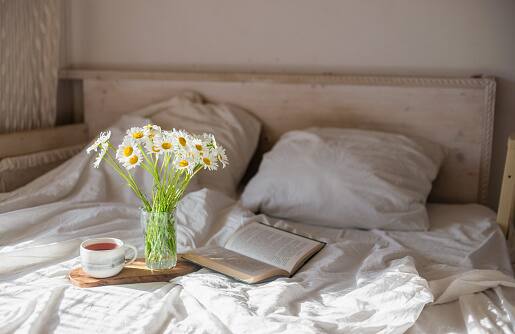 Upgrade Your Bedding: Investing in quality bedding can make a world of difference during the summer months. Linen is naturally cooling, moisture-wicking, and gets softer with each wash, making it an ideal choice for summer bedding. Pair it with lightweight duvets or blankets for a restful night's sleep. (Image Source: Getty)