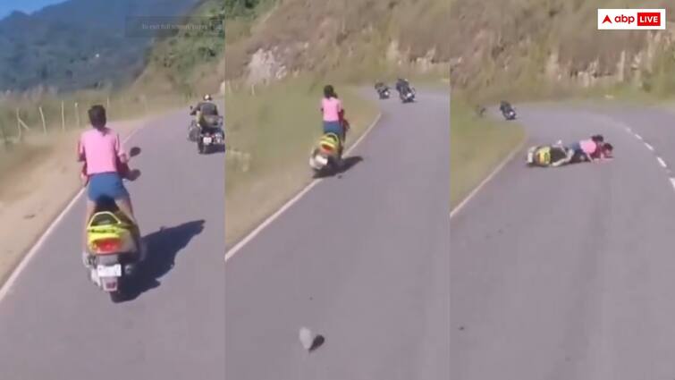 Road accident Two girls riding a scooter while racing with a bike became victims of an accident police share video Video: पहाड़ों में स्कूटी पर खड़े होकर टशन दिखा रही थी लड़की, कुछ ही देर बाद छिल गए घुटने- पुलिस ने शेयर किया वीडियो