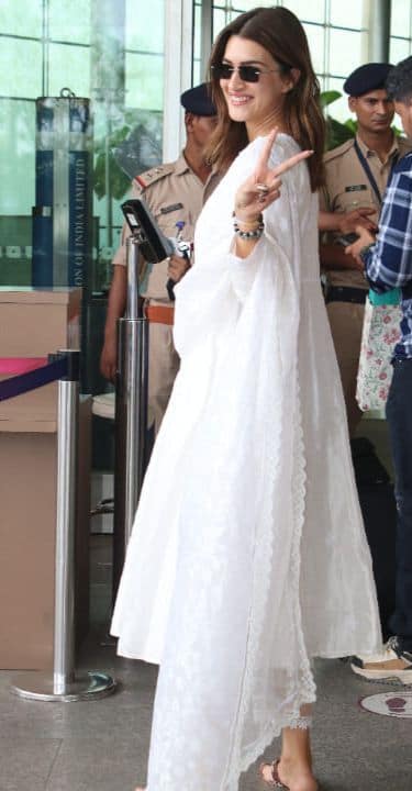 कृति सनोन ने एयरपोर्ट पर एक सफ़ेद सूट और एक नाज़ुक पारदर्शी दुपट्टे में सबका ध्यान अपनी ओर आकर्षित किया। उनके इस लुक को एक जोड़ी ठाठदार काले धूप के चश्मे ने पूरा किया, जो उनके पारंपरिक पहनावे में एक आधुनिक स्पर्श जोड़ रहा था।