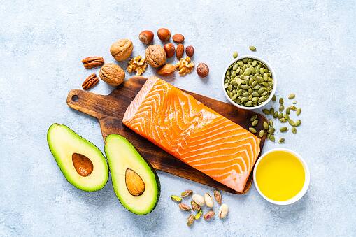 Omega-3 Fatty Acids: Foods rich in omega-3 fatty acids, such as fatty fish, flaxseeds, and walnuts, provide lubrication to the joints, reduce inflammation, and alleviate arthritis symptoms. (Image Source: Getty)