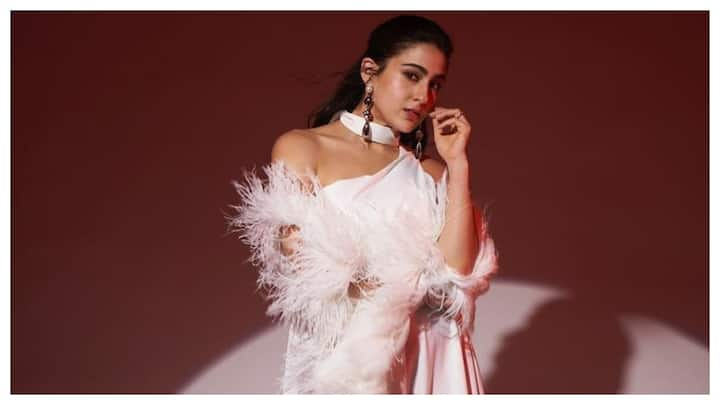 Actress Sara Ali Khan, who is known for her impeccable fashion sense, treated her fans to mesmerising pictures in a white thigh-high slit gown with feather sleeves.