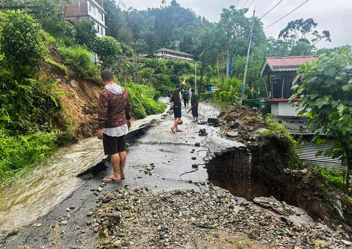 Section of a road damaged due to landslides triggered by incessant rainfall, at Mangan in North Sikkim. (Image Source: PTI)