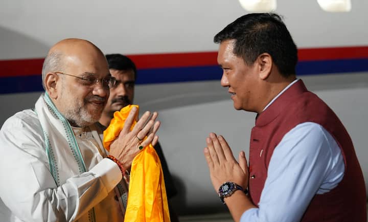 Union Minister Amit Shah being welcomed by Arunachal Pradesh Chief Minister-designate Pema Khandu upon his arrival at the airport, in Itanagar. (Image Source: PTI)