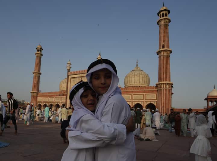 Children greet each other after offering 'namaz' on the occasion of the 'Eid al-Adha' festival, at Jama Masjid in New Delhi. (Image source: PTI)