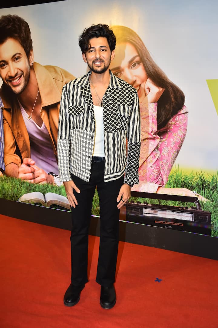 Singer Darshan Raval poses happily as he arrives for the screening.