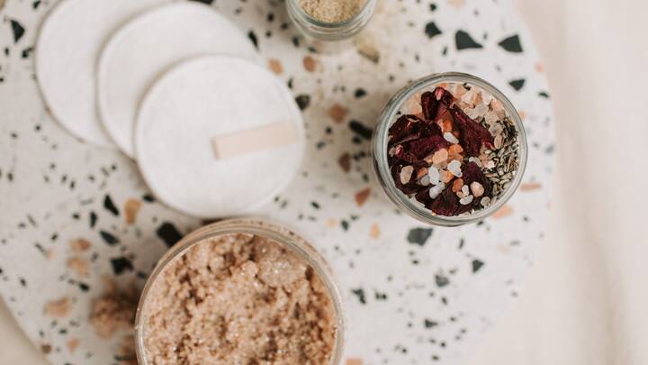 Exfoliate (1-2 times a week): Gently exfoliating once or twice a week can make a big difference. It helps remove dead skin cells and unclog pores, enhancing the absorption of your skincare products. Consider using a mild exfoliant with ingredients like lactic acid or salicylic acid for a smoother complexion. (Image Source: Canva)