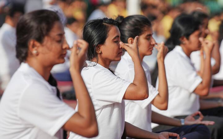 People perform yoga on the 10th International Day of Yoga, at Vidhana Soudha, in Bengaluru. (Image Source: PTI)