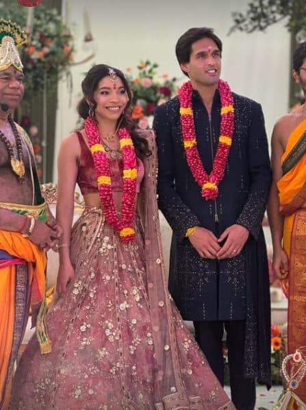 Sidhartha wore a navy blue sherwani for his big day. The ensemble featured a Chinese collar, zip closure at the front, and gold sequin designs spread across the outfit,