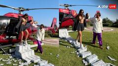 इसे कहते हैं पैसों की गर्मी...गर्लफ्रेंड के पैरों तले बिछा दिए करोड़ों रुपये के नोट, वीडियो वायरल