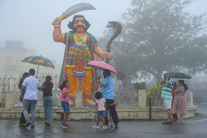 People use umbrellas to shield themselves during rain, in Mysuru, Wednesday, June 26, 2024. (Image Source: PTI)