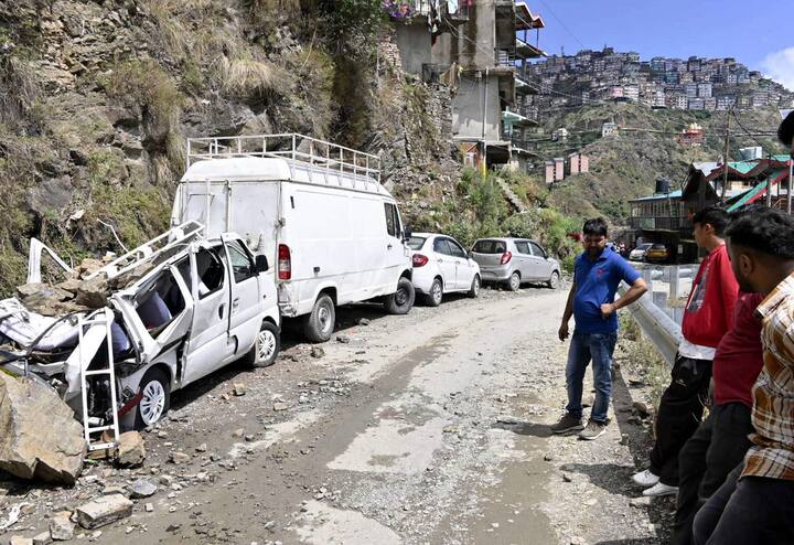 People look at vehicles damaged after landslides triggered by heavy rainfall, in Shimla, Friday, June 28, 2024. (Image source: PTI)