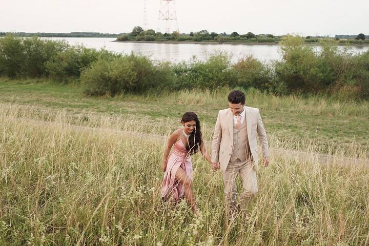 Michael perfectly complements her in a nude pink pantsuit.