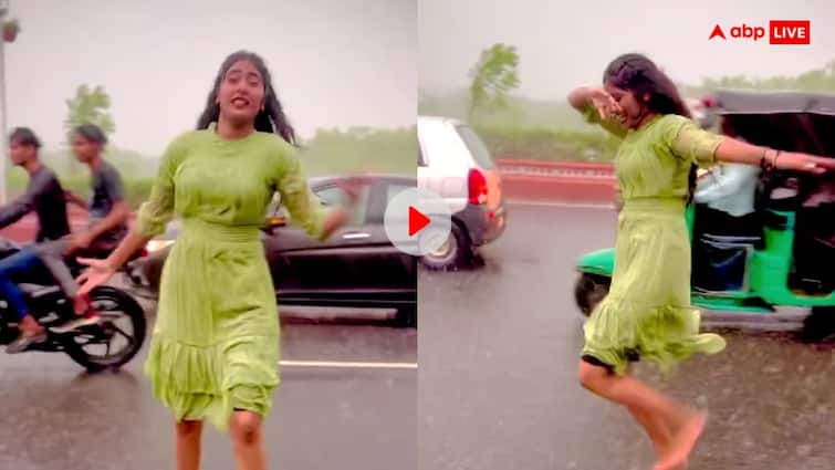 Rain dance Video of a girl dancing to the tune of a song in the middle of the road is going viral Viral Video: रिमझिम में बीच सड़क पर जमकर नाची ग्रीन सूट वाली, यूजर्स बोले- बरसात आते ही उड़ने लगीं तितलियां