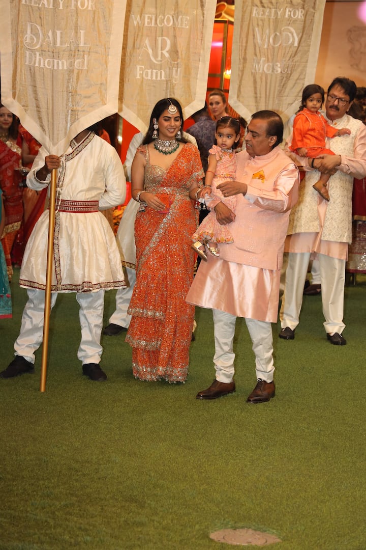 Isha Ambani also looked dapper in an orange saree