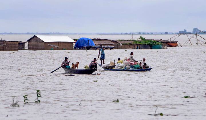 Villagers use a boat to cross a flood-affected area along with their belongings, in Morigaon district, on Monday, July 1, 2024. (Image Source: PTI)