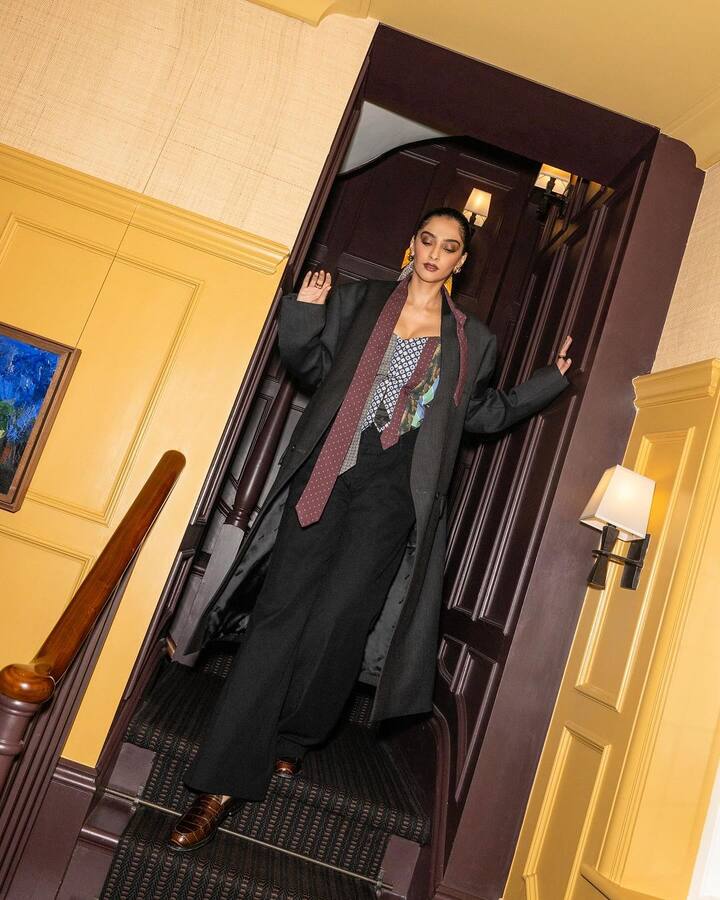 Sonam's stylish outfit features a waistcoat top with a corset fit and a variety of fabrics, including a tie.