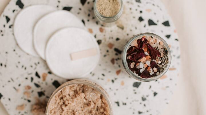 Regularly exfoliate with a mild exfoliant to keep your pores clean and prevent acne. (Image Source: Canva)