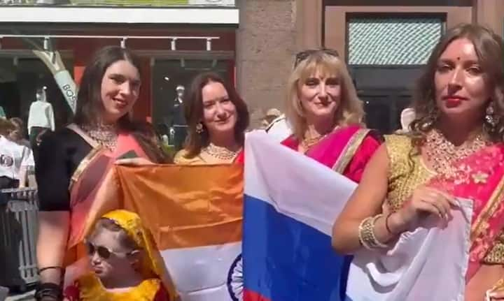 Russian devotees sing bhajans outside the hotel in Moscow, where PM Narendra Modi is scheduled to arrive. (Image Source: ANI)