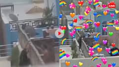 बारिश के बीच छत पर रोमांस करने लगा कपल, दीवार पर चढ़कर किया किस- वायरल हुआ वीडियो