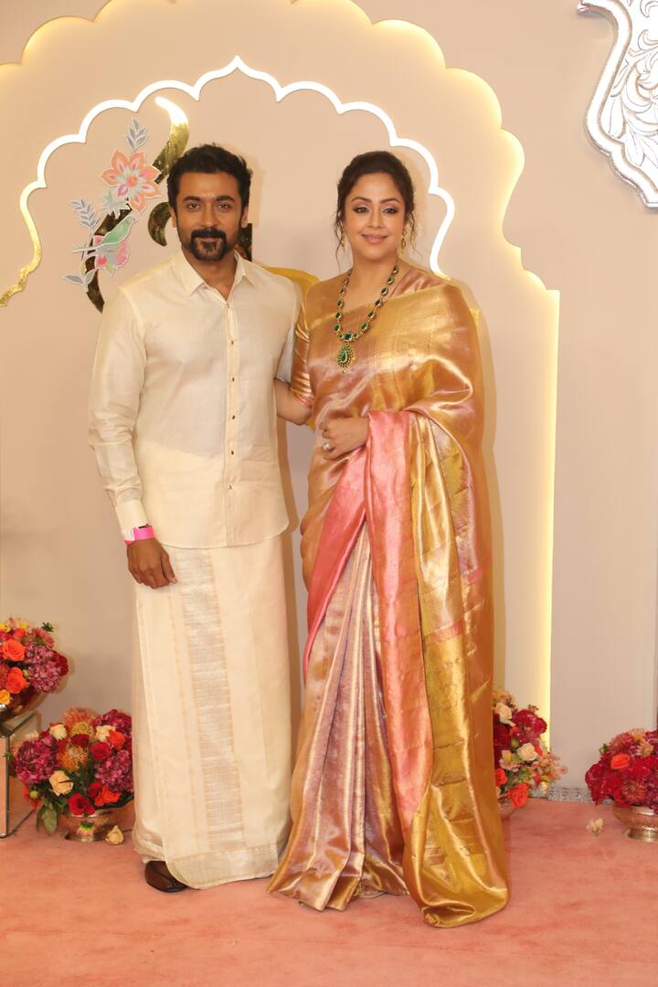 Actor Suriya poses with his wife and actor Jyothika.