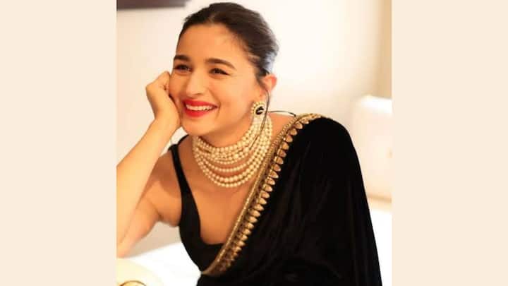 1. Alia Bhatt: Alia Bhatt looks absolutely stunning in this black saree adorned with pearls. Her red lipstick perfectly complements the ensemble, adding a touch of classic elegance.  (Image source: Special Arrangement)