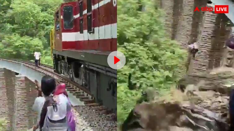 Couple jump into 90 feet deep ditch to escape train video goes viral Viral Video: फोटोशूट में यूं डूबा कपल कि नजर नहीं आई ट्रेन, फिर 90 फीट ऊंचे ब्रिज पर लिया ऐसा खौफनाक फैसला