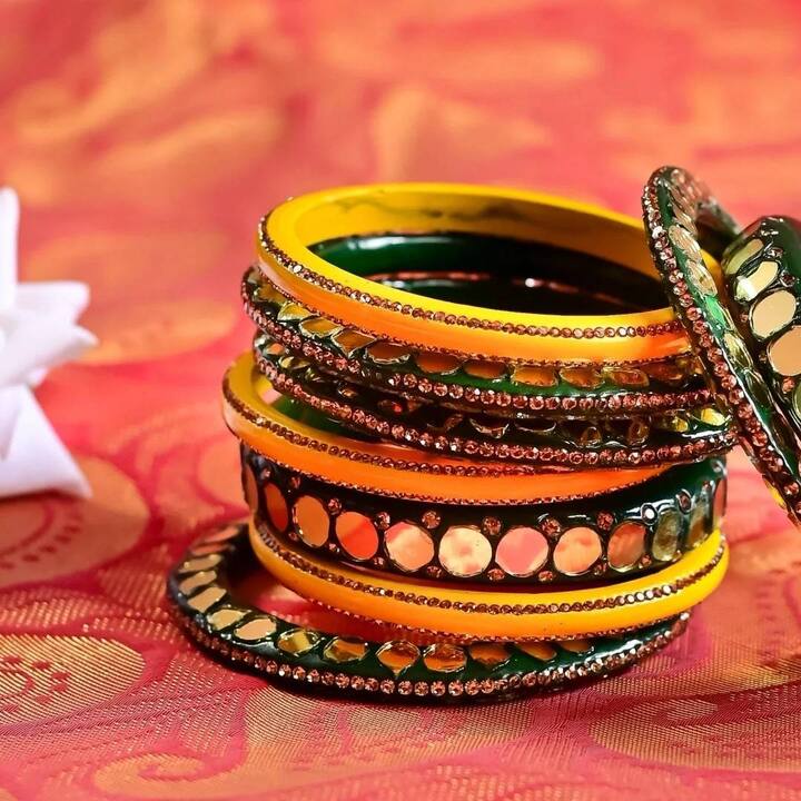 This green bangle has gold stones on it. You can also wear it like this on your hands, especially those women who go to office and do not want to carry heavy bangle sets. It can also be worn with designer bangles while going to a party.