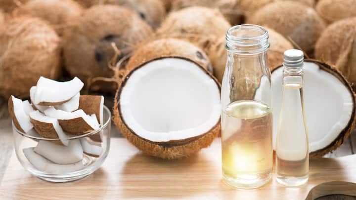 Coconut Oil: There are two types of coconut oil- a plant-based oil derived from coconut meat: coconut oil used for frying, and virgin coconut oil, which is directly consumable and more suitable for a ketogenic diet. Due to its high saturated fat content, it's solid at room temperature. However, it has a relatively low smoke point of 350°F (177°C), making it more suitable for baking and low-heat cooking. One downside is that it imparts a coconut flavour to dishes. (Image Source: Canva)