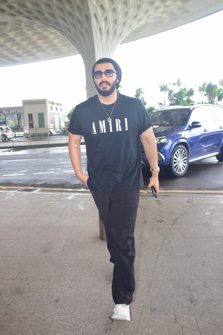 He completed his look with a black beanie, glasses and white sneakers.