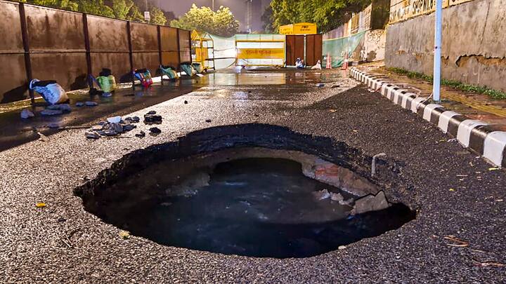 A caved-in portion of a road near Hauz Khas after heavy showers that disrupted normal life in the national capital. (Photo: PTI)