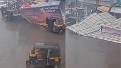 ఈదురు గాలులకు కుప్ప కూలిన భారీ హోర్డింగ్, రెప్పపాటులో తప్పించుకున్న మహిళ - వీడియో