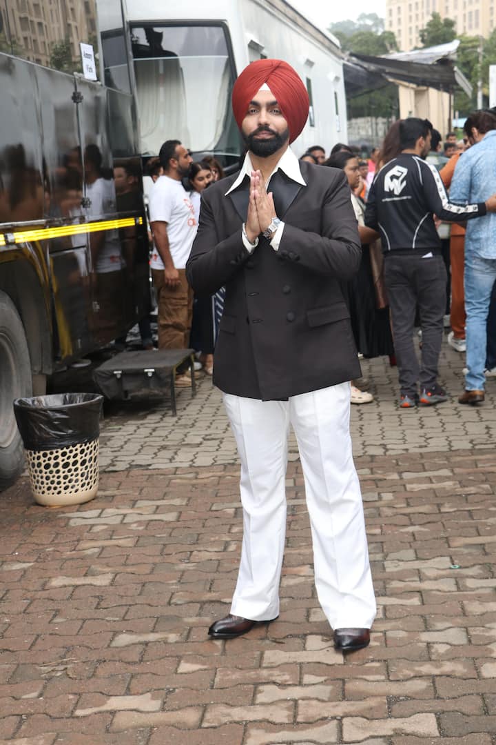 Ammy Virk looked dapper in a black coat and white pant.