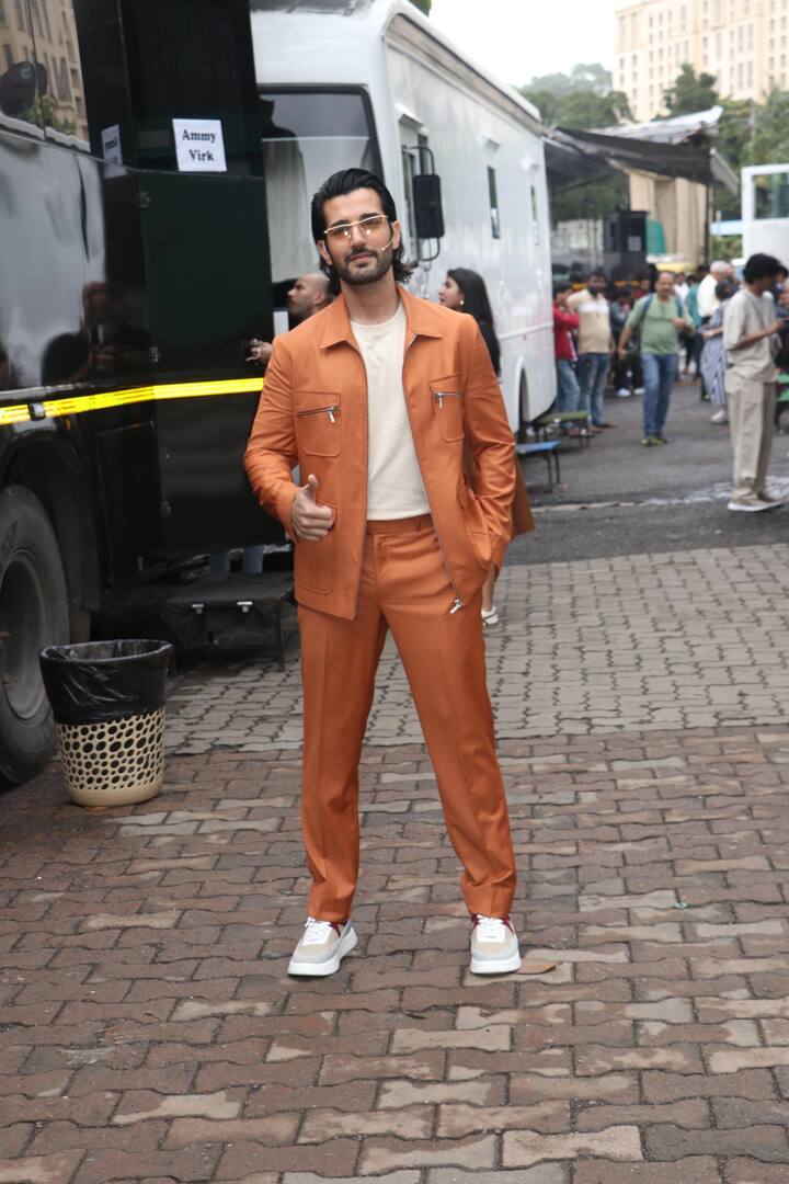 Aditya Seal wore an orange jacket and pant with white t-shirt and sneakers.