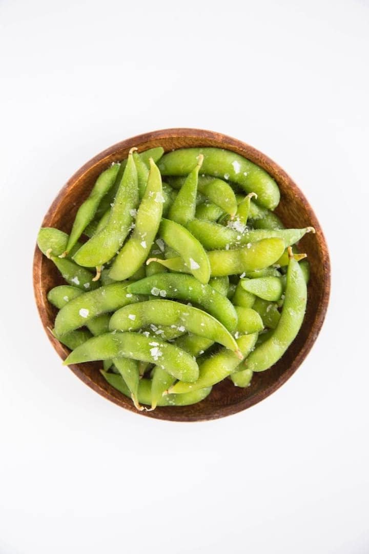 Enjoy edamame: Edamame (tender soybeans) are packed with protein and fiber. They can be enjoyed warm or cold and are easy to prepare ahead of time. Buy pre-cooked edamame or steam them. Sprinkle with a little sea salt or your favorite seasoning. Store them in the refrigerator for a quick, protein-packed snack. They're great to eat during a busy work day or after a workout. (Image source: Pinterest/The kitchn)