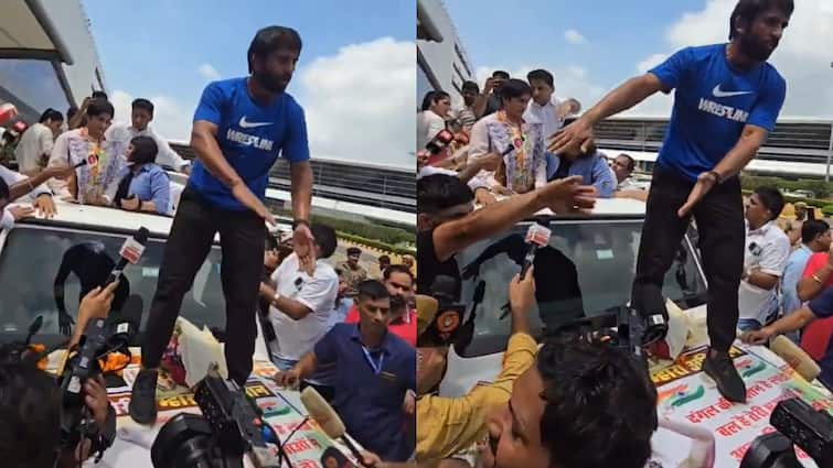 Bajrang Punia Stands On Indian Flag Tiranga Receiving Vinesh Phogat At Delhi Airport Criticised Bajrang Punia Stands On Poster With Indian Flag While Receiving Vinesh Phogat At Delhi Airport; Criticised