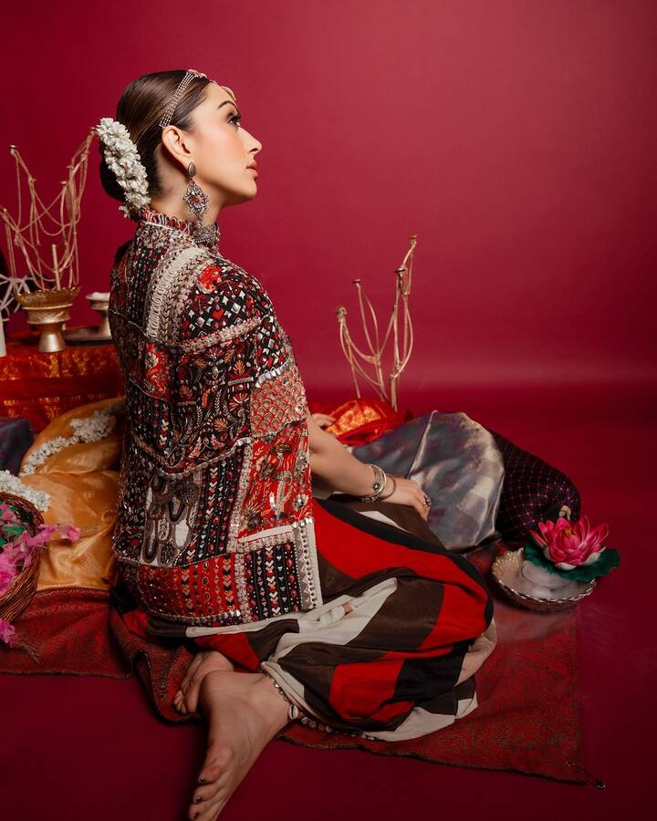 Hansika styled her hair in a sleek high bun which was decorated with flowers.