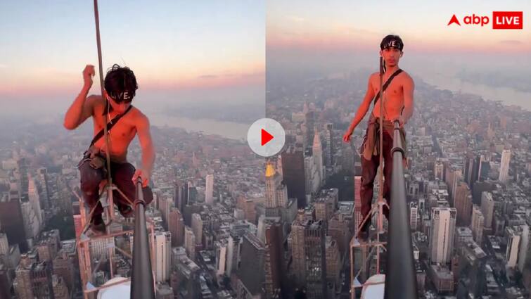 Man took a selfie while standing on the antenna of the Empire Building video goes viral वीडियो देखकर ही खिसक जाएगी आपके पैरों तले जमीन, शख्स ने गगनचुंबी बिल्डिंग पर ली ऐसी खतरनाक सेल्फी