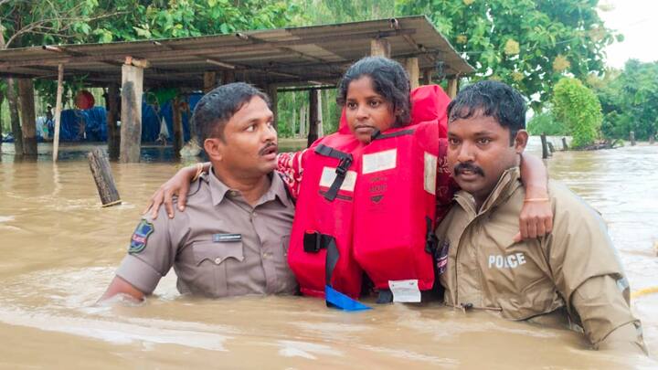 Rescue officials save a girl in a flood-affected area, in Bhadradri Kothagudem district, Telangana, Monday, Sept. 2, 2024. (Image Source: PTI)