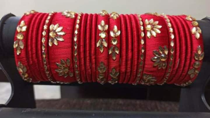 4. Red and Gold Embroidered Thread Bangles: For a softer, more casual look, red and gold embroidered thread bangles are a great choice. They offer a traditional, effortless look and are ideal for daytime Teej celebrations. A lightweight cotton saree or a simple yet elegant salwar-kameez allows you to stay comfortable without sacrificing style. (Image source: Pinterest/ebay)