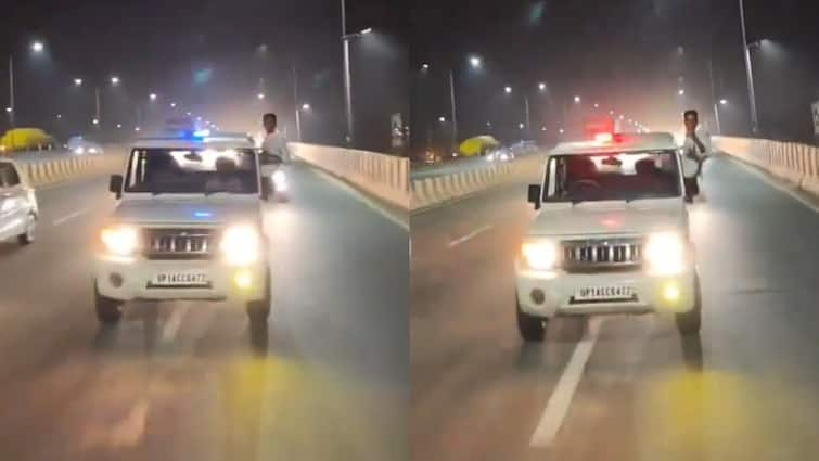 On Camera: Youth Hangs Out Of UP Government Vehicle With Police Siren Over On Ghaziabad Highway; 2 Held UP: Youth Hangs Out Of Government Vehicle With Police Siren On Ghaziabad Highway — Viral Video