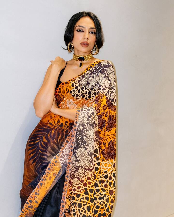 She tied her hair back in a low bun with curtain bangs framing her face.