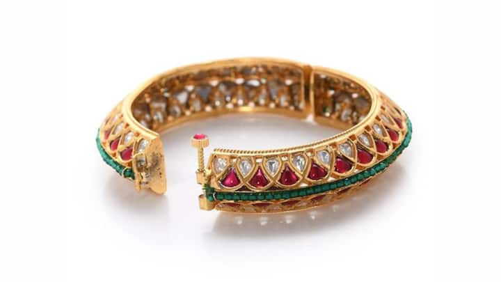 5. Red Polki Bangles with Crystal Embellished: Polki bangles, characterized by their signature chunky shape and intricate designs, are best suited for special occasions. The uncut stones and crystal embellishments make your outfit look more elegant and traditional. Very beautiful and elaborate heavy silk lehengas or sarees, particularly the ones in red, gold, deep jewelled and other bold colours, are perfect to pair with these bangles. (Image Source: Pinterest/etsy)