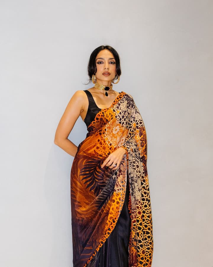 For accessories, the actress opted for big golden hoops and a golden choker with dangling black oval pendant.