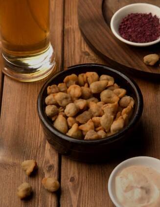 Alcohol is often bitter and it becomes easier to drink after eating a few salty peanuts. In fact, peanuts affect our taste buds in such a way that the bitterness of the alcohol becomes less noticeable later.