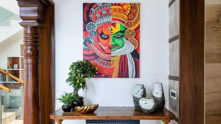 10. Celebrate with Onam-themed wall art: Liven up your walls with Kerala-themed paintings or prints, featuring dancers in traditional dances like Kathakali, elephants, or temple artwork. These pieces give the festive decor the much-needed extra layers. (Image source: Pinterest/architectsdiary)