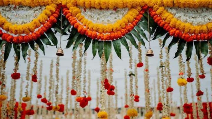 8. Create a festive entrance: To attract attention to the main door, you can use colorful rangolis, torans, and bells hung on the walls. This adds beauty to the building and at the same time welcomes the guest in a noble manner. (Image source: Pinterest/wedmegood)