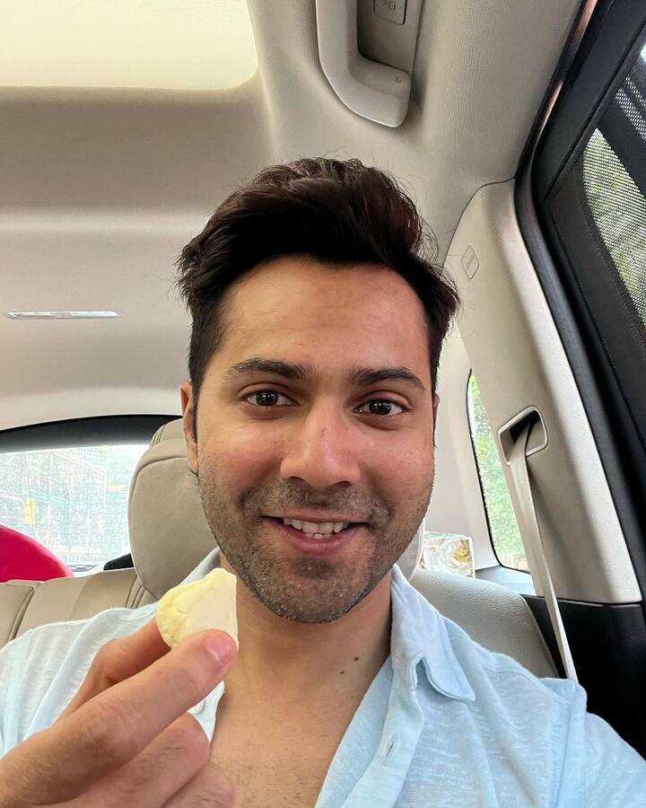One of the photos, show him holding a modak. (Image: Instagram/@varundvn)