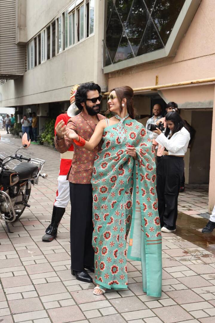 The actress looked breathtaking in an aqua-green saree with vivid orange flower designs.